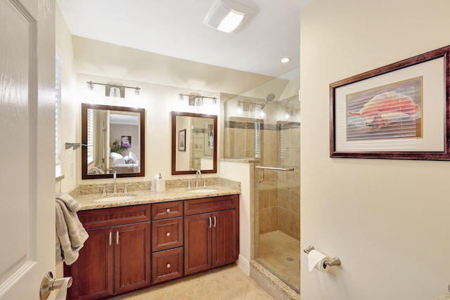 full bath featuring double vanity, a stall shower, tile patterned floors, and a sink