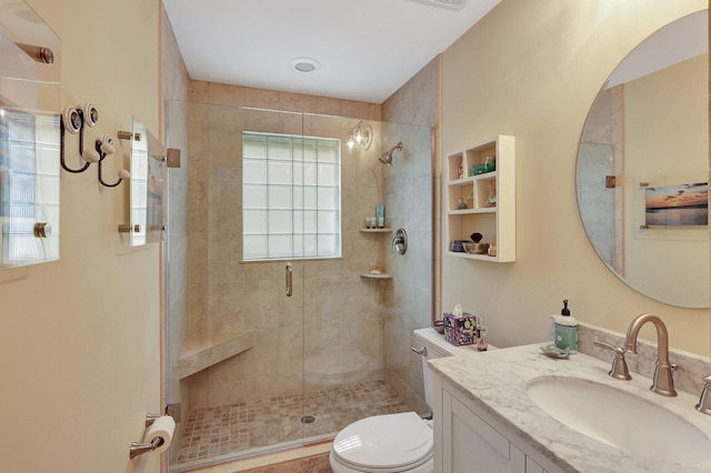 full bathroom with vanity, toilet, and a stall shower