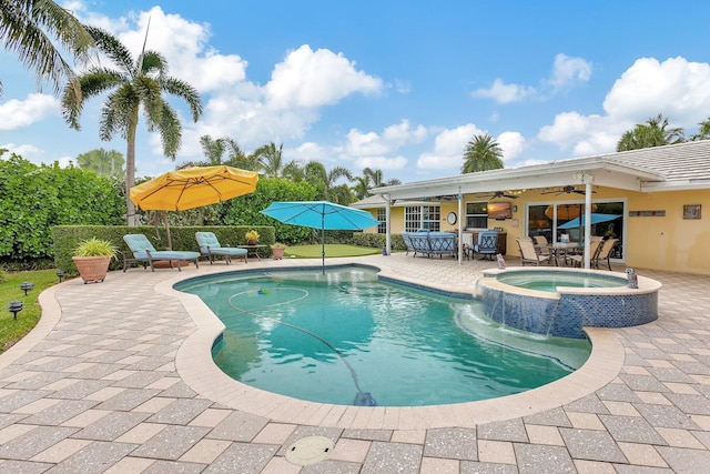 view of swimming pool with a patio, ceiling fan, outdoor dining space, and a pool with connected hot tub