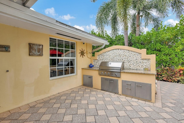 view of patio / terrace with area for grilling and an outdoor kitchen