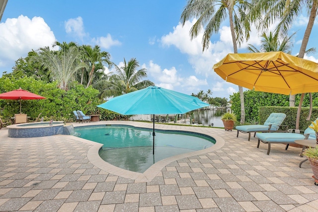 view of pool with a patio and a pool with connected hot tub