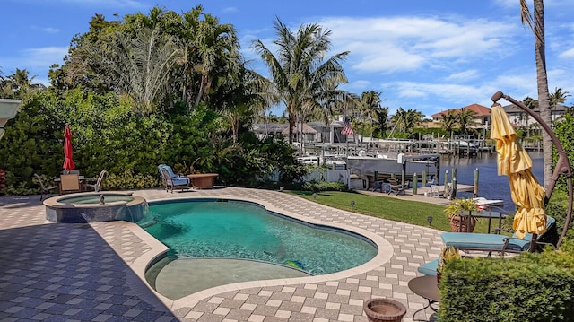 view of pool featuring a lawn, a pool with connected hot tub, a dock, and a patio area