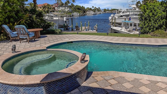 view of swimming pool with a pool with connected hot tub, a patio area, a dock, and a water view