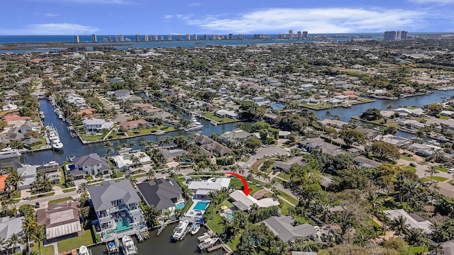 drone / aerial view with a residential view, a view of city, and a water view