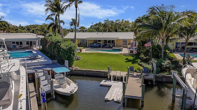 dock area featuring an outdoor pool, a yard, a water view, and a patio