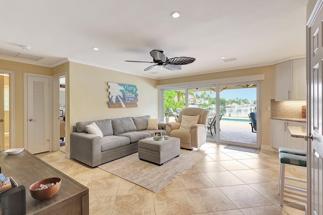 living room featuring light tile patterned floors, a ceiling fan, ornamental molding, and recessed lighting