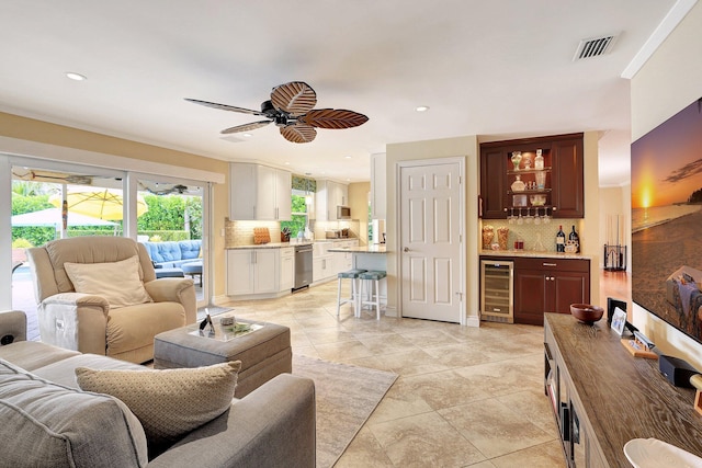 living area featuring visible vents, recessed lighting, wine cooler, a bar, and ceiling fan