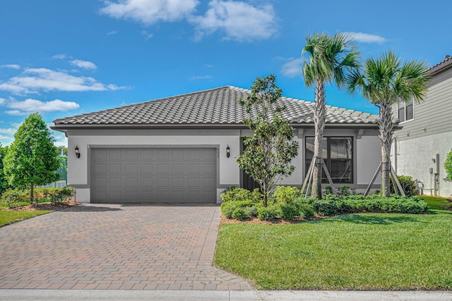 view of front of property featuring a front lawn and a garage