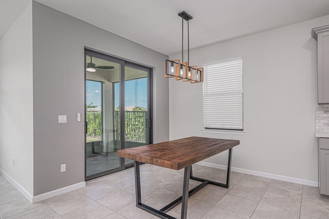 dining room with light tile patterned flooring and a notable chandelier