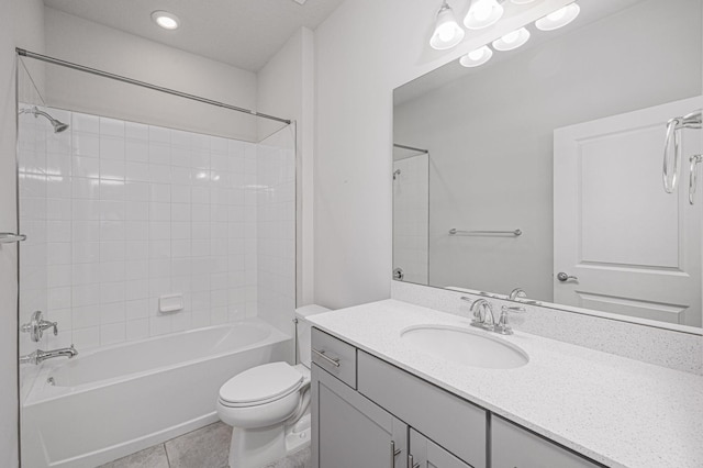 full bathroom featuring tile patterned floors, vanity, toilet, and tiled shower / bath