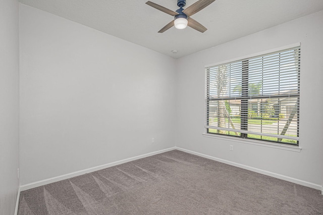 empty room with ceiling fan and carpet