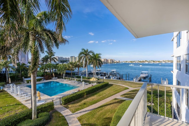 view of swimming pool with a water view and a dock