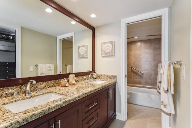 full bathroom featuring tile patterned flooring, vanity, toilet, and tiled shower / bath