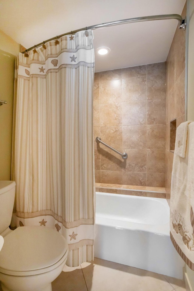 bathroom with tile patterned floors, toilet, and shower / tub combo