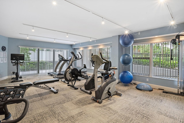 gym featuring carpet flooring and track lighting