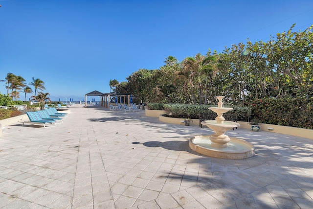 view of pool with a water view and a patio area