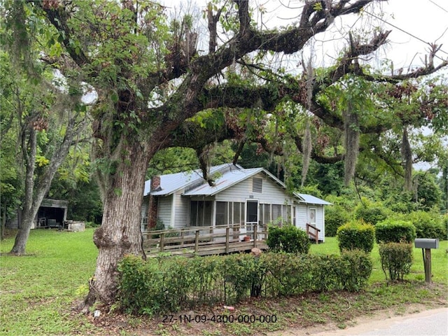 view of front facade with a front yard and a deck