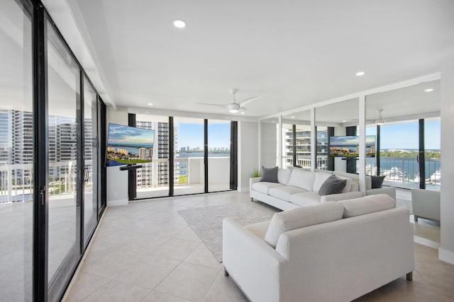 tiled living room featuring a wall of windows and ceiling fan