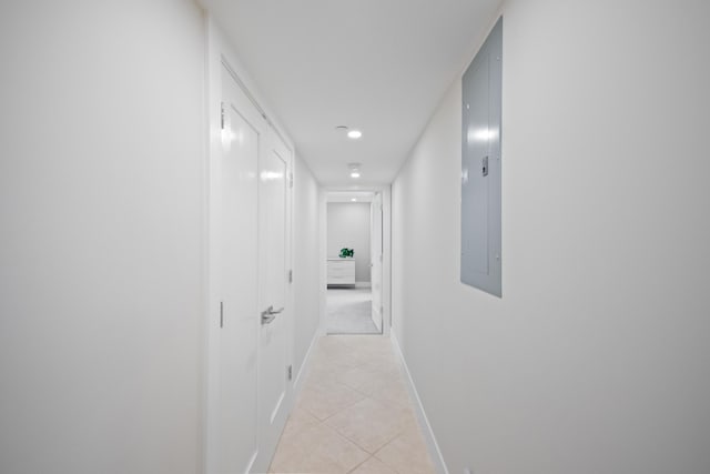 hallway featuring light tile patterned flooring and electric panel