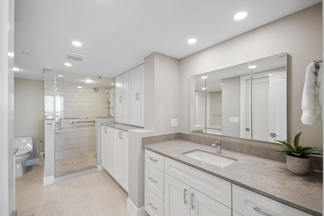 bathroom with vanity, toilet, and walk in shower