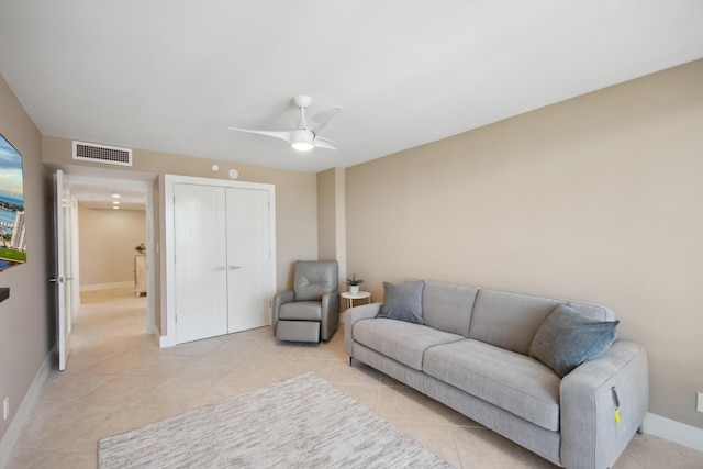 tiled living room featuring ceiling fan