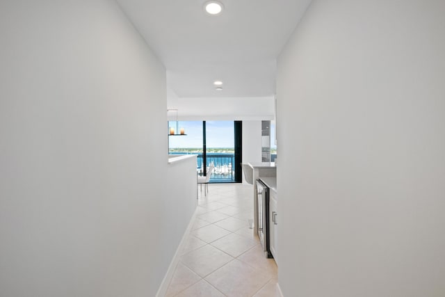 hallway with light tile patterned floors and beverage cooler