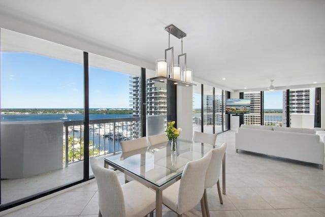 tiled dining area with a wall of windows, plenty of natural light, and ceiling fan