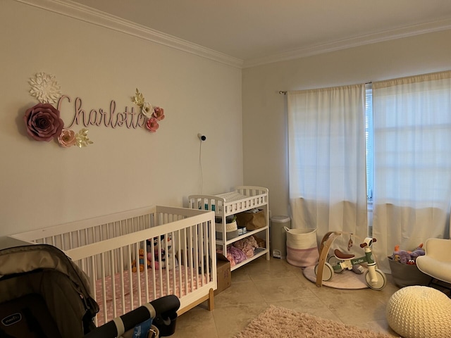 bedroom with tile patterned floors, a nursery area, and crown molding