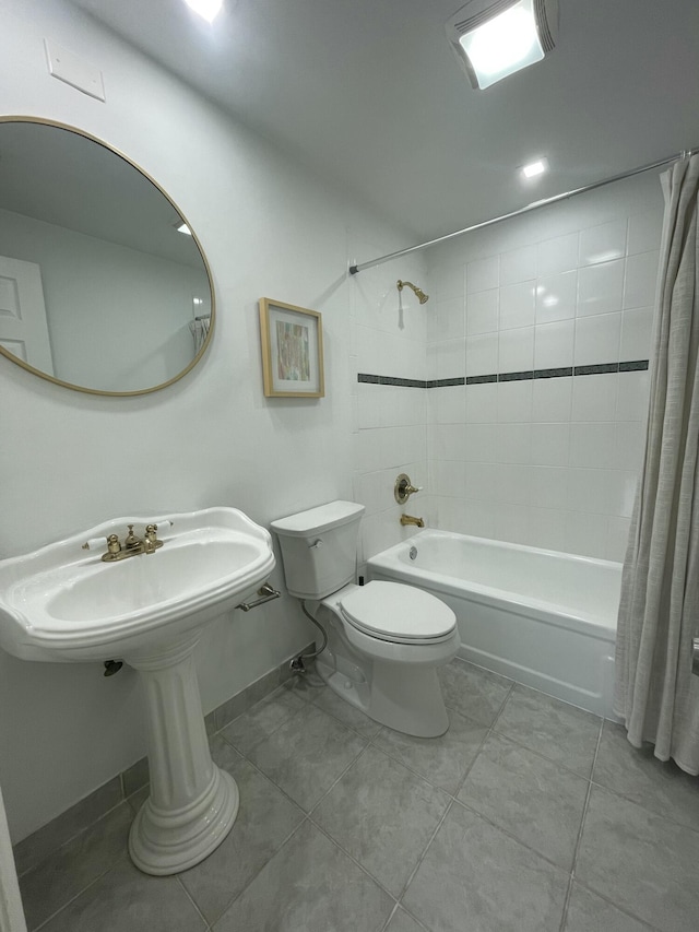 bathroom featuring tile patterned flooring, shower / bath combination with curtain, and toilet