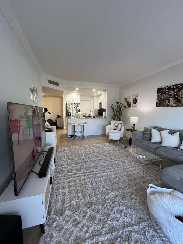 living room featuring hardwood / wood-style floors and crown molding