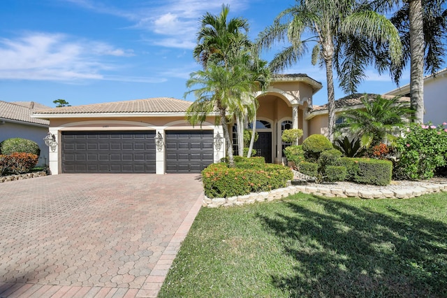 view of front of house with a front lawn and a garage