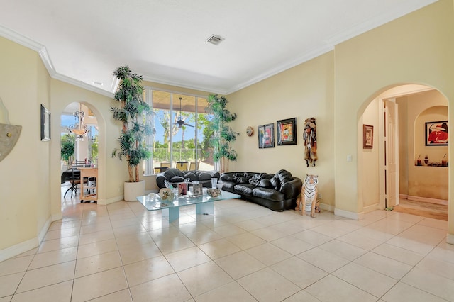 living room with an inviting chandelier, ornamental molding, and light tile patterned flooring