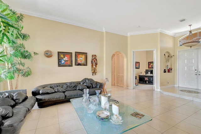 living room featuring light tile patterned floors and crown molding