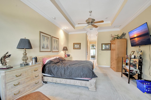 bedroom featuring a raised ceiling, ceiling fan, light carpet, and ornamental molding