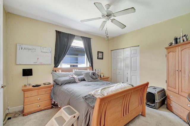 bedroom featuring light carpet, a closet, and ceiling fan