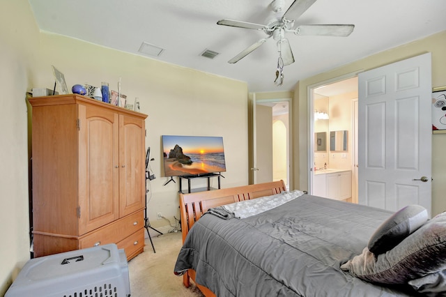 carpeted bedroom with ceiling fan and ensuite bathroom