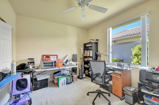 carpeted office space with ceiling fan