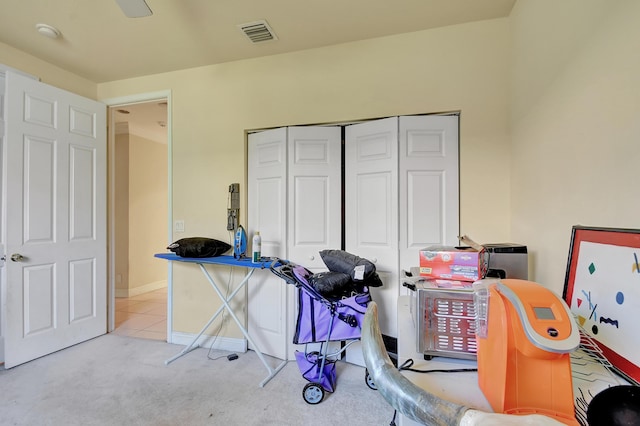 recreation room with light colored carpet