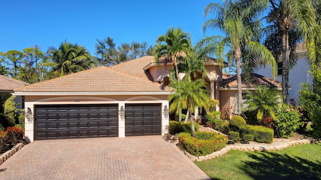 mediterranean / spanish-style home with a garage