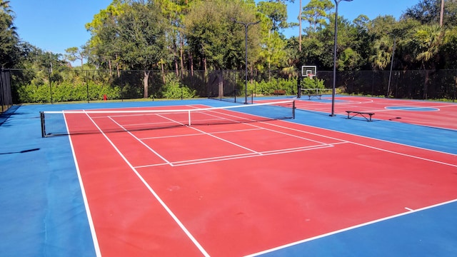 view of tennis court featuring basketball court