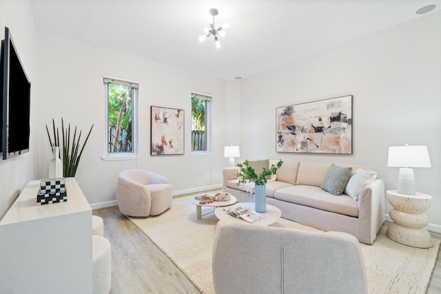 living room featuring a chandelier and light hardwood / wood-style flooring