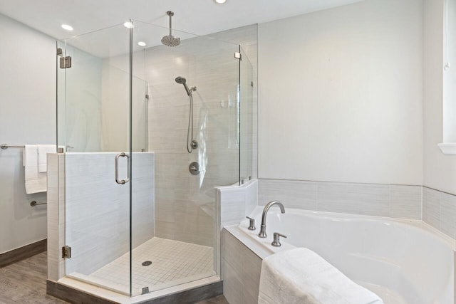 bathroom with wood-type flooring and separate shower and tub