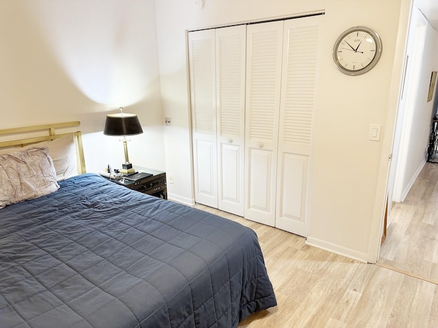 bedroom featuring light hardwood / wood-style floors and a closet