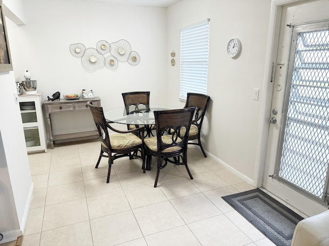 tiled dining space with a healthy amount of sunlight