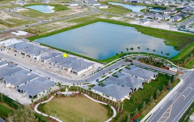 birds eye view of property with a residential view and a water view