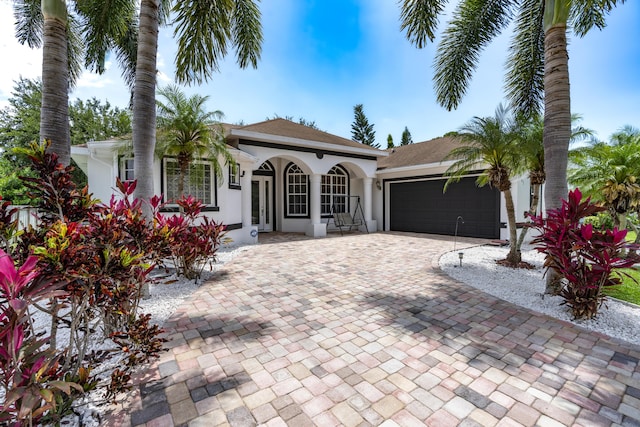 view of front of house with a porch and a garage