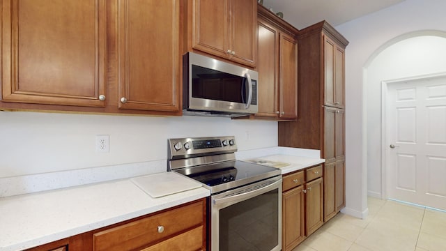 kitchen with stainless steel appliances and light tile patterned flooring