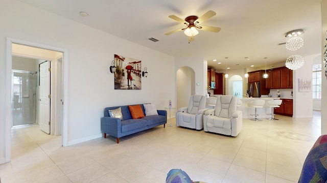 tiled living room with ceiling fan