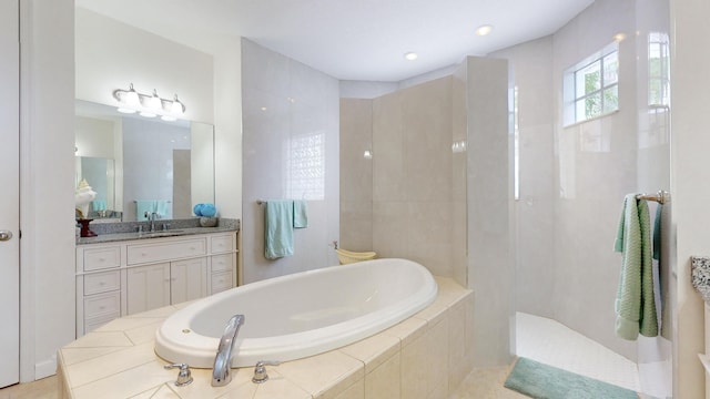 bathroom with shower with separate bathtub, vanity, and tile patterned floors