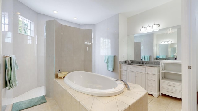 bathroom with plus walk in shower, vanity, and tile patterned floors